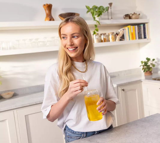 Woman drinking Herbalife Fibre Concentrate Sweet Orange Goji Berry